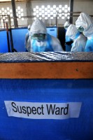 The first class of volunteers who will work in Ebola treatment units search a simulated room for possible contaminates during medical training at the National Police Training Center, Paynesville, Liberia, Oct. 30, 2014. The participants work through various scenarios they may encounter while caring for Ebola and Ebola-symptomatic patients. The medical training is conducted by the DoD Ebola Training Team under the Joint Forces Command – United Assistance, which supports the U.S. Agency for International Development in the effort to control the spread of Ebola.  (Sgt. 1st Class Nathan Hoskins/U.S. Army)