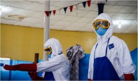 Health care workers prepare to go through a simulated Ebola treatment unit in Buchanan City, Nov. 21, 2014. The mobile training team gives the health care workers the tools to work in an ETU. The MTT travels to remote locations in Liberia so workers can easily attend the training. Operation United Assistance is a Department of Defense operation in Liberia to provide logistics, training and engineering support to U.S. Agency for International Development-led efforts to contain the Ebola virus outbreak in western Africa. (Staff Sgt. Terrance D. Rhodes/U.S. Army)