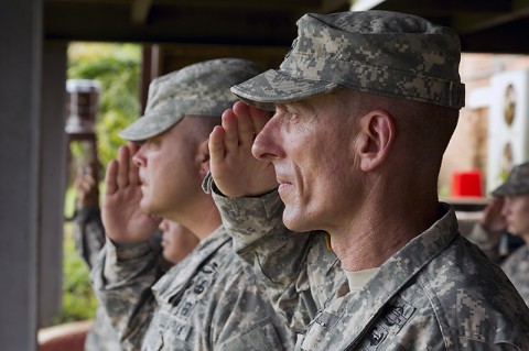 Maj. Gen. Gary Volesky, Commander of Joint Force Command - United Assistance (JFC-UA), and Command Sgt. Maj. Kirk Hines, Acting Senior Enlisted Adviser for JFC-UA, render honors to the colors at the guide-on uncasing for 101st Sustainment Brigade in Firestone, Liberia on Nov. 12, 2014. United Assistance is a Department of Defense operation to provide command and control, logistics, training and engineering support to U.S. Agency for International Development-led efforts to contain the Ebola virus outbreak in West African nations. (Sgt. 1st Class Brien Vorhees)