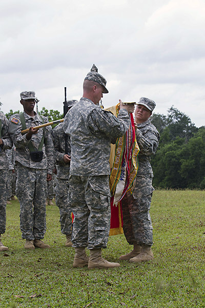 Col. Kimberly Daub, commander of the 101st Sustainment Brigade, Task Force Lifeliner, and Command Sgt. Maj. Ian Griffin, the brigade senior enlisted adviser, uncase their unit’s colors in a ceremony held in Firestone, Monrovia Province, Liberia on Nov. 11, 2014. Task Force Lifeliner, the JTF-UA sustainment asset about the logistical efforts being made and planned for Operation United Assistance. (Sgt. 1st Class Mary Rose Mittlesteadt)