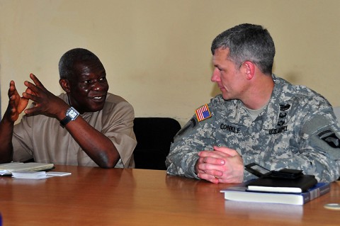 T. Edward Liberty, left, Ph.D., the director general of the Liberian Institute of Statistics – Geo-Information Services, discusses his vision of his newfound partnership with the Joint Forces Command – United Assistance geospatial team with Lt. Col. David Conkle, the assistant chief of staff of intelligence for JFC-UA, during a meeting Oct. 29, 2014, at the LISGIS headquarters in Monrovia. (Sgt. 1st Class Nathan Hoskins)