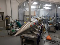 The Rapid Acquisition Imaging Spectrograph Experiment is seen peeking out of a clean room during the weeks of testing before its scheduled November 2014 launch. (NASA/RAISE)
