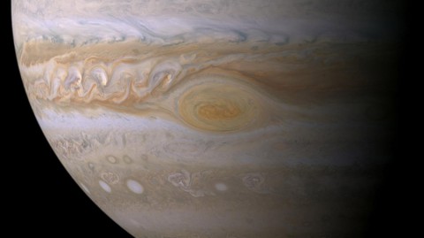 Research suggests effects of sunlight produce the color of Jupiter's Great Red Spot. The feature's clouds are much higher than those elsewhere on the planet, and its vortex nature confines the reddish particles once they form. (NASA/JPL-Caltech/ Space Science Institute) Research suggests effects of sunlight produce the color of Jupiter's Great Red Spot. The feature's clouds are much higher than those elsewhere on the planet, and its vortex nature confines the reddish particles once they form. (NASA/JPL-Caltech/ Space Science Institute)