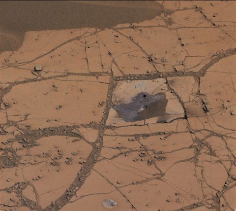 This image shows the first holes drilled by NASA's Mars rover Curiosity at Mount Sharp. The loose material near the drill holes is drill tailings and an accumulation of dust that slid down the rock during drilling. (NASA/JPL-Caltech/MSSS)