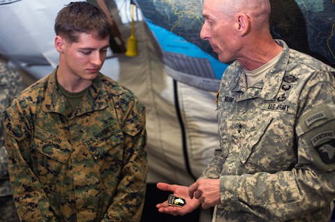 Marine Cpl. Brandon Gohn, left, team leader, Company F, 2nd Battalion, 2nd Marine Regiment, Camp LeJeune, N.C., receives a coin and is recognized by Maj. Gen. Gary Volesky, the Joint Forces Command – United Assistance commander, at the Barclay Training Center in Monrovia, Liberia, Nov. 28, 2014. This Friday marked the beginning of a weekly recognition program for the troops who are deployed to Liberia in support of Operation United Assistance. Gohn is the first to be recognized as Service Member of the Week. (Spc. Rashene Mincy, 55th Signal Company)