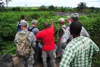 A team comprised of representatives from Joint Forces Command – United Assistance, the Armed Forces of Liberia, and the U.S. Agency for International Development – the lead U.S. agency charged with containing the spread of Ebola in West Africa – along with city officials in Ganta, Liberia, survey an area for construction of an Ebola treatment unit Nov. 3, 2014. The team included Maj. Gen. Gary Volesky, the JFC-UA commander, who said the visit was successful. (U.S. Army photo by Sgt. 1st Class Nathan Hoskins)