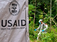 Maj. Benjamin Qi, commander, 61st Preventative Medicine Detachment, 86th Combat Support Hospital, Fort Campbell, Ky., sprays insecticide around the area where a health clinic is currently being built in Gbediah, Liberia. Operation United Assistance is a Department of Defense operation in Liberia to provide logistics, training and engineering support to U.S. Agency for International Development-led efforts to contain the Ebola virus outbreak in western Africa. (Sgt. Matt Britton/U.S. Army)