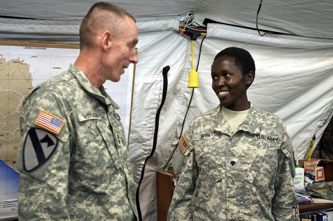 Specialist Rysper Sirma, food inspection specialist, 463rd Medical Detachment (Veterinary Services), Joint Forces Command – United Assistance, is recognized for her exemplary performance while supporting Operation United Assistance by Maj. Gen. Gary Volesky, commander of JFC-UA, Dec. 26, 2014, at the Barclay Training Center, Monrovia, Liberia. Each week a service member supporting OUA is formally recognized by Volesky, who awards him or her with a division coin, followed by a helicopter ride with the commander around the joint operations area. Operation United Assistance is a Department of Defense operation in Liberia to provide logistics, training and engineering support to U.S. Agency for International Development-led efforts to contain the Ebola virus outbreak in western Africa. (Staff Sgt. V. Michelle Woods/U.S. Army)