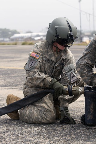 Spc. Danielle Taylor, a flight engineer and a fuel handler instructor with 2nd General Support Aviation Battalion, 501st Aviation Regiment, 1st Armored Division Aviation Brigade, from Fort Bliss, Texas, teaches a fuel handler’s class to Soldiers from the 101st Sustainment Brigade, Task Force Lifeliners, Joint Forces Command - United Assistance, deployed in support of Operation United Assistance at Roberts International Airport outside of Monrovia, Liberia, Jan. 15, 2014. (Sgt. 1st Class Mary Rose Mittlesteadt, 101st Sustainment Brigade Public Affairs)