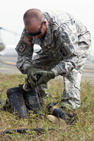 Sgt. Jarred Calvert, a fuel handler with the 101st Sustainment Brigade, Task Force Lifeliners, Joint Forces Command - United Assistance, deployed in support of Operation United Assistance, checks a fuel hose coupling cap during a fuel handler’s class at Roberts International Airport outside of Monrovia, Liberia, Jan. 15, 2014. (Sgt. 1st Class Mary Rose Mittlesteadt, 101st Sustainment Brigade Public Affairs)