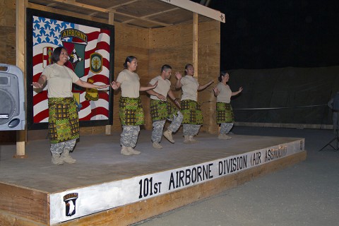 From left, Sgt. 1st Class Christabel Jennings, Warrant Officer Abigail Baker, Pfc. Timothy Cruz, Spc. Sally Rodriguez and Maj. Jessica Higa, all with the 101st Sustainment Brigade, Task Force Lifeliner, Joint Forces Command – United Assistance, dance the Pate Pate dance for the Buchanan talent show to celebrate the New Year at Camp Buchanan, Buchanan, Liberia, Dec. 31, 2014. (Sgt. 1st Class Mary Rose Mittlesteadt, 101st Sustainment Brigade Public Affairs)