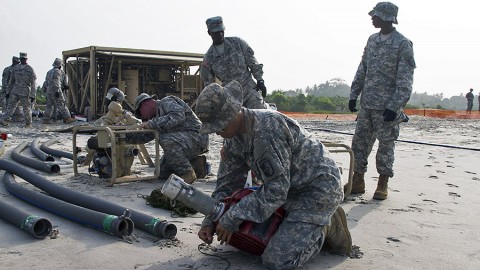 Pvt. 1st Class Tieyu Zhang with the 227th Quartermaster Company, 129th Combat Sustainment Support Battalion, 101st Sustainment Brigade, Task Force Lifeliners, Joint Task Force - United Assistance, prepares a pump to be put into the seawater as part of the employment of a tactical water purification system (TWPS) at a waterfront in Buchanan, Liberia, on Jan. 8, 2015. The TWPS is a logistical capability that is used to provide clean water for forces supporting Operation United Assistance. (Sgt. 1st Class Mary Rose Mittlesteadt, 101st Sustainment Brigade)