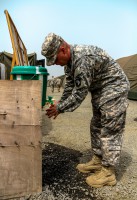 Capt. Austin Duckwiler, native of Davenport, Iowa, department joint automations management officer, Signal Company, Headquarters and Headquarters Battalion, 101st Airborne Division (Air Assault), washes his hands thoroughly with a bleach-water solution before entering the dining facility at Barclay Training Center, Monrovia, Liberia, Jan. 13, 2015. Buckets filled with a bleach-water solution are stationed outside of camp facilities with a higher personnel traffic volume to promote hand washing and prevent spread of any possible bacterial transmissions. Operation United Assistance is a Department of Defense operation in Liberia to provide logistics, training and engineering support to U.S. Agency for International Development-led efforts to contain the Ebola virus outbreak in western Africa. (Spc. Caitlyn Byrne/U.S. Army)