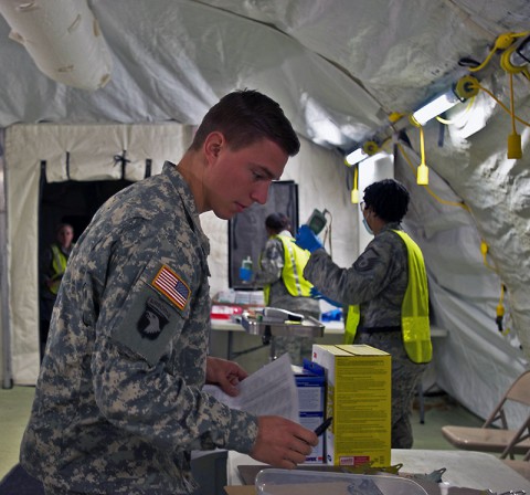 First Lt. Dan Thueneman, executive officer, Intelligence and Sustainment Company, Headquarters and Headquarters Battalion, 101st Airborne Division (Air Assault), fills out the signs and symptoms checklist before he has his temperature taken, during his 21-day controlled monitoring period at Joint Base Langley – Eustis, Va., Jan. 20, 2015. (U.S. Army photo by Sgt. Matt Britton 27th Public Affairs Detachment/Released)