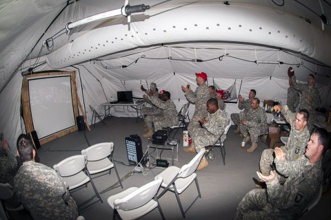 Soldiers deployed in support of Operation United Assistance in Monrovia, Liberia, cheer after their Ohio State University Buckeyes score a final touchdown and win the College Football Playoff Championship game, Jan. 13, 2015. The dedicated fans stayed up until 5 a.m. when the game ended.  (U.S. Army photo by Sgt. 1st Class Nathan Hoskins, 101st Airborne Division Public Affairs)