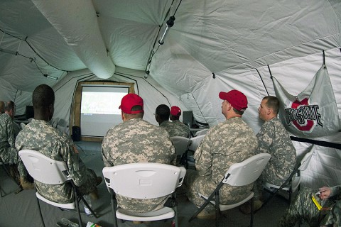 Soldiers deployed in support of Operation United Assistance in Monrovia, Liberia, watch their Ohio State University Buckeyes during the College Football Playoff Championship game, Jan. 13, 2015. The dedicated fans stayed up until 5 a.m. when the game ended. (U.S. Army photo by Sgt. 1st Class Nathan Hoskins, 101st Airborne Division Public Affairs)