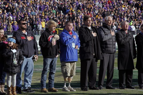 Eight wounded warriors, their families, and two Gold Star families were invited to the Franklin American Mortgage Music City bowl to be honored during each event leading up to the game on Dec. 30, 2014. Before the game, the group stood on the field during the singing of the national anthem.