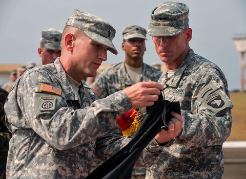 Command Sgt. Maj. Gregory Nowak, left, Joint Forces Command – United Assistance and 101st Airborne Division (Air Assault) senior enlisted adviser, and Maj. Gen. Gary Volesky, commander of JFC-UA and 101st, case their unit colors during a ceremony held at the Barclay Training Center, Monrovia, Liberia, Feb. 26, 2015. (Spc. Rashene Mincy, 55th Signal Company (Combat Camera))