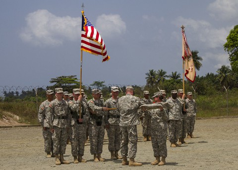 Col. Kimberly Daub, right, commander of the 101st Sustainment Brigade, Task Force Lifeliner, the logistical element for Joint Forces Command – United Assistance, and Command Sgt. Maj. Ian Griffin, the brigade senior enlisted advisor, case their unit’s colors in a ceremony held in Buchanan, Grand Bassa County, Liberia, Feb. 24, 2015. The casing ceremony signifies the completion of the logistical mission for Operation United Assistance for the 101st Sustainment Brigade. (Sgt. First Class Mary Rose Mittlesteadt, 101st Sustainment Brigade (Lifeliners))