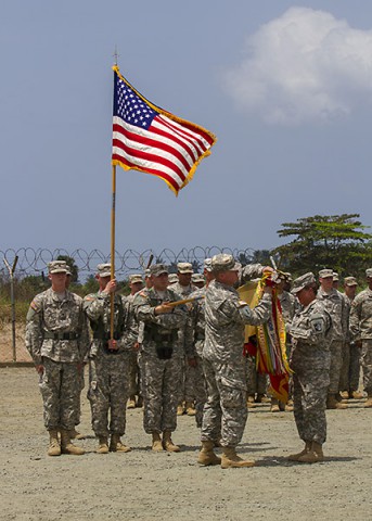 Col. Kimberly Daub, right, commander of the 101st Sustainment Brigade, Task Force Lifeliner, the logistical element for Joint Forces Command – United Assistance, and Command Sgt. Maj. Ian Griffin, the brigade senior enlisted adviser, case their unit’s colors in a ceremony held in Buchanan, Grand Bassa County, Liberia, Feb. 24, 2015. (Sgt. First Class Mary Rose Mittlesteadt, 101st Sustainment Brigade (Lifeliners))