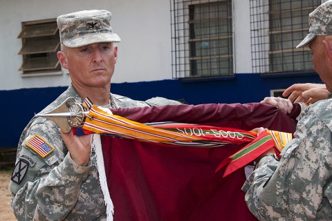 Col. Edward Bailey, commander of Task Force Eagle Medic and the 86th Combat Support Hospital based out of Fort Campbell, KY, cases his unit’s colors during a ceremony at the National Police Training Academy, Paynesville, Liberia, Feb. 12, 2015. The 86th CSH, deployed as Task Force Eagle Medic in support of Operation United Assistance, will head back to Fort Campbell, KY.  (Sgt. 1st Class Nathan Hoskins, 101st Airborne Division Public Affairs)