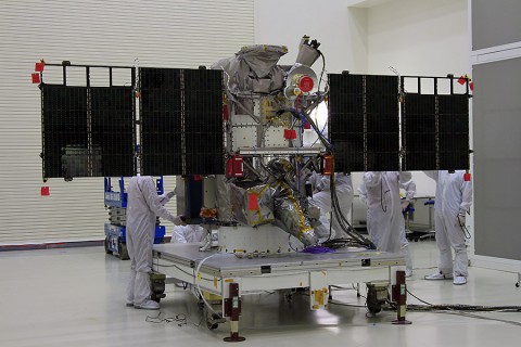 The solar arrays on NOAA’s Deep Space Climate Observatory spacecraft, or DSCOVR, are unfurled in the Building 1 high bay at the Astrotech payload processing facility in Titusville, Florida, near Kennedy Space Center. (NASA/Ben Smegelsky)