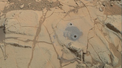 Gray cuttings from Curiosity's drilling into a target called "Mohave 2" are visible surrounding the sample-collection hole in this Jan. 31, 2015, image from the rover's MAHLI camera. This site in the "Pahrump Hills" outcrop provided the mission's second drilled sample of Mars' Mount Sharp. (NASA/JPL-Caltech/MSSS)