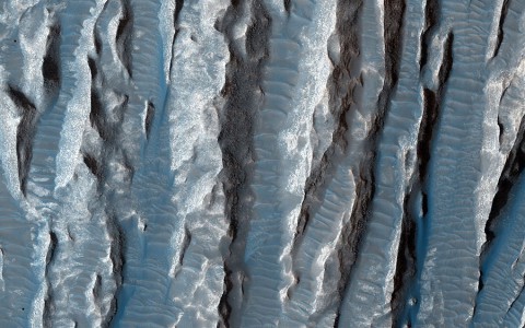 This view of Martian surface features shaped by effects of winds was captured by the HiRISE camera on NASA's Mars Reconnaissance Orbiter on Jan. 4, 2015. The spacecraft has been orbiting Mars since March 2006. On Feb. 7, 2015, it completed its 40,000th orbit around Mars. (NASA/JPL-Caltech/Univ. of Arizona) This view of Martian surface features shaped by effects of winds was captured by the HiRISE camera on NASA's Mars Reconnaissance Orbiter on Jan. 4, 2015. The spacecraft has been orbiting Mars since March 2006. On Feb. 7, 2015, it completed its 40,000th orbit around Mars. (NASA/JPL-Caltech/Univ. of Arizona)