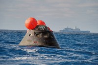 NASA’s Orion spacecraft awaits the U.S. Navy’s USS Anchorage for a ride home. Orion launched into space on a two-orbit, 4.5-test flight at 7:05am EST on Dec. 5, and returned safely splashed down in the Pacific Ocean. (U.S. Navy)