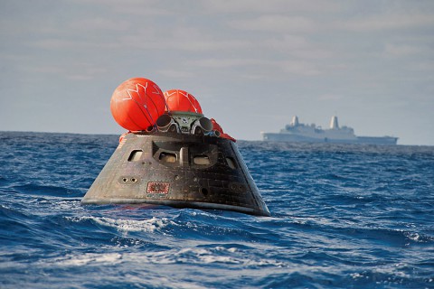 NASA's Orion spacecraft awaits the U.S. Navy's USS Anchorage for a ride home. Orion launched into space on a two-orbit, 4.5-test flight at 7:05am EST on Dec. 5, and returned safely splashed down in the Pacific Ocean. (U.S. Navy)