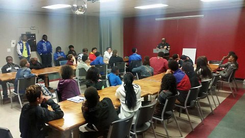 Sidney Brown speaks to youth enrolled in the LEAP youth development program.