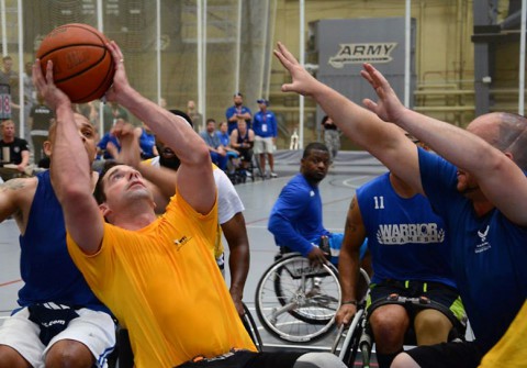 Staff Sgt. Brian Boone, Fort Sam Houston, Texas, maneuvers around his competitor for a layup during the during the game opener of Wheelchair Basketball competition June 16th at the 2014 U.S. Army Trials. 