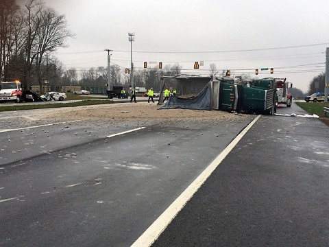 A dump truck traveling eastbound on Purple Heart Parkway struck the driver side of a four-door car traveling northbound on Evans Road.