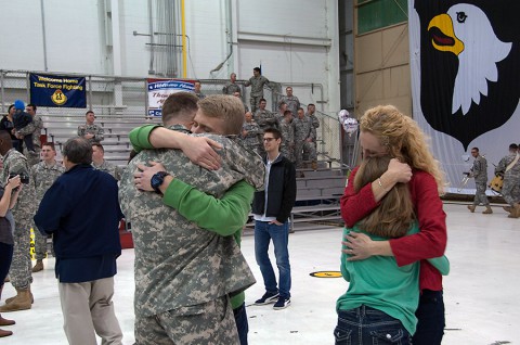 Division Chaplain (Lt. Col.) David Bowlus hugs his son Andrew, while his wife Meridee hugs their daughter Savannah, moments after reuniting during a welcome home ceremony March 11 at Fort Campbell. Bowlus was one of 59 Soldiers that returned from a deployment in support of Operation United Assistance. (Sgt. Leejay Lockhart, 101st Sustainment Brigade Public Affairs)