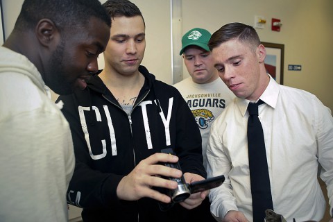 From left, film collaborators Spc. Randall Fletcher, Pfc. Robert Blackmore, Spc. Kevin Booth and Spc. John Russino review playback of a recent scene for a film project created during an I Was There film workshop at Fort Campbell. (David E. Gillespie)