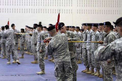 Capt. Lucas Brown, commander of the 39th Company C, 39th Brigade Engineer Battalion, 2nd Brigade Combat Team, 101st Airborne Division, unfurls his company colors during the reactivation ceremony for the 39th BEB April 16, 2015, at Freedom Fighters Physical Fitness Center here. (Sgt. David Cox, 2BCT PAO)