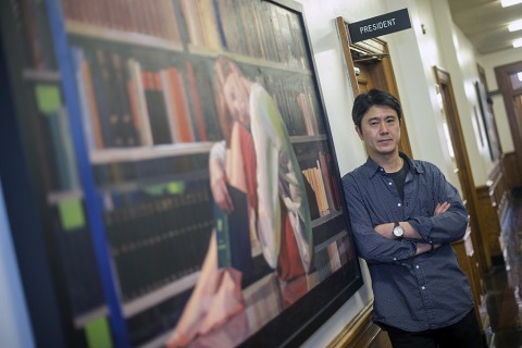 Artist Takuya Kanemitsu poses next to his painting “After the Library Closed” in the Browning Administration Building. (Beth Liggett, APSU)