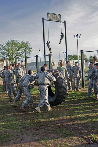 Soldiers of Company D, 1st Battalion, 327th Infantry Regiment, 1st Brigade Combat Team, 101st Airborne Division (Air Assault), work as a squad to complete their tire flips during the best squad physical fitness competition April 10. Those who had already finished the competition showed their support for the Soldiers still completing the challenge. (Sgt. Samantha Parks, 1st Brigade Combat Team)