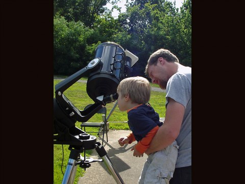 A child learning how to look through a telescope. (LBL Staff)