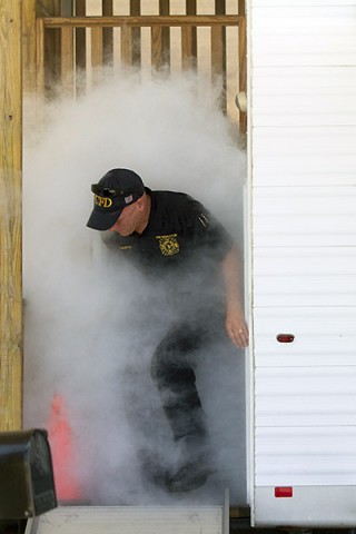 Darrell Brantley, a member of the Fort Campbell fire prevention team, demonstrates exiting a trailer that simulates smoke filled houses to members of the 716th Military Police Battalion, supported by the 101st Sustainment Brigade, 101st Airborne Division, during a battalion safety training exercise May 1, 2015, at Fort Campbell, Ky. Fire prevention was one of several safety topics the battalion trained on during the event. (Sgt. Leejay Lockhart, 101st Sustainment Brigade, 101st Airborne Division (Air Assault) Public Affairs)