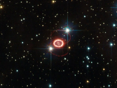 The still unraveling remains of supernova 1987A are shown here in this image taken by NASA's Hubble Space Telescope. The bright ring consists of material ejected from the dying star before it detonated. The ring is being lit up by the explosion's shock wave. (ESA/Hubble & NASA)