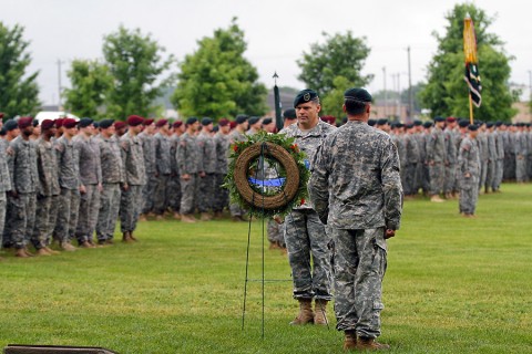 Col. John W. Brennan, the commander of the 5th Special Forces Group (Airborne), prepares to move a memorial wreath into place during the annual 5th SFG(A) Memorial Ceremony on Gabriel Field, May 16, 2015, at Fort Campbell, KY. (Sgt. Justin A. Moeller, 5th SFG(A) Public Affairs)