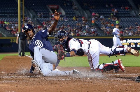 Atlanta Braves catcher Christian Bethancourt (27) tags out San Diego Padres Melvin Upton, Jr. (2) in the eighth inning at Turner Field. The Braves won 6-5. (Jason Getz-USA TODAY Sports)