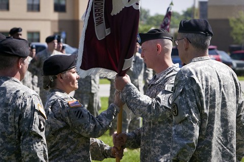 During a relinquishment of command ceremony Thursday, Lt. Col. Bryan J. Walrath accepts the Warrior Transition Battalion colors from Command Sgt. Maj. Staci Rea. The battalion's executive officer, Maj. Jamey Turner will serve as interim commander. (U.S. Army photo by David E. Gillespie)