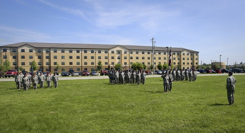 The Warrior Transition Battalion serves as a fitting backdrop from an adjacent parade field June 4, as Lt. Col. Bryan J. Walrath ceremoniously relinquishes his position after serving as the unit's commander for the last two years.