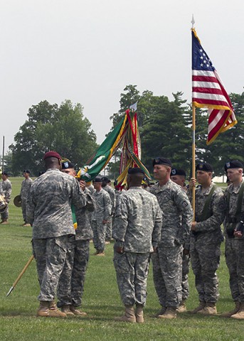 Lt. Col. Michael Johnston, incoming commander of the 716th Military Police Battalion, 101st Sustainment Brigade, 101st Airborne Division (Air Assault), takes the unit colors from Col. Alexander Conyers, commander of the 16th Military Police Brigade, during a change of command ceremony June 25, 2015, at the division parade field here. (Sgt. 1st Class Mary Rose Mittlesteadt, 101st Sustainment Brigade, 101st Airborne Division Public (Air Assault) Public Affairs)