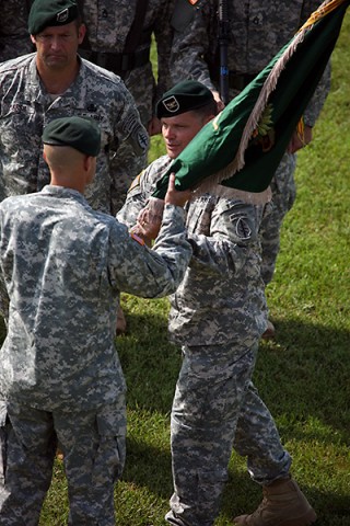 Col. John W. Brennan passes the 5th Special Forces Group (Airborne) colors to Brig. Gen. Darsie D. Rogers, the commanding general of 1st Special Forces Command (Airborne) (Provisional), during the 5th SFG(A) change of command ceremony on Gabriel Field, July 16, 2015. (Sgt. Seth Plagenza, 5th SFG(A) Combat Camera)