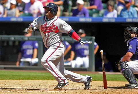 Atlanta Braves third baseman Juan Uribe (2) hits a single during the fourth inning against the Colorado Rockies at Coors Field. The Rockies won   3-2. (Chris Humphreys-USA TODAY Sports)