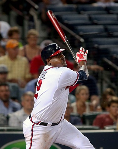 Atlanta Braves third baseman Juan Uribe (2) singles on a fly ball scoring a run in the fifth inning of their game against the Los Angeles Dodgers at Turner Field. (Jason Getz-USA TODAY Sports)