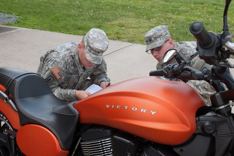 Sgt. Andrey Kolomiytsev and Sgt. Clayton Russell both with the 2nd Battalion, 44th Air Defense Artillery Regiment, 101st Sustainment Brigade, 101st Airborne Division, conduct an inspection on a motorcycle during pre-riding check and training session to kick off the Motorcycle Safety Month on May 6, 2015. (Sgt. 1st Class Mary Rose Mittlesteadt, 101st Sustainment Brigade, 101st Airborne Division Public (Air Assault) Affairs)